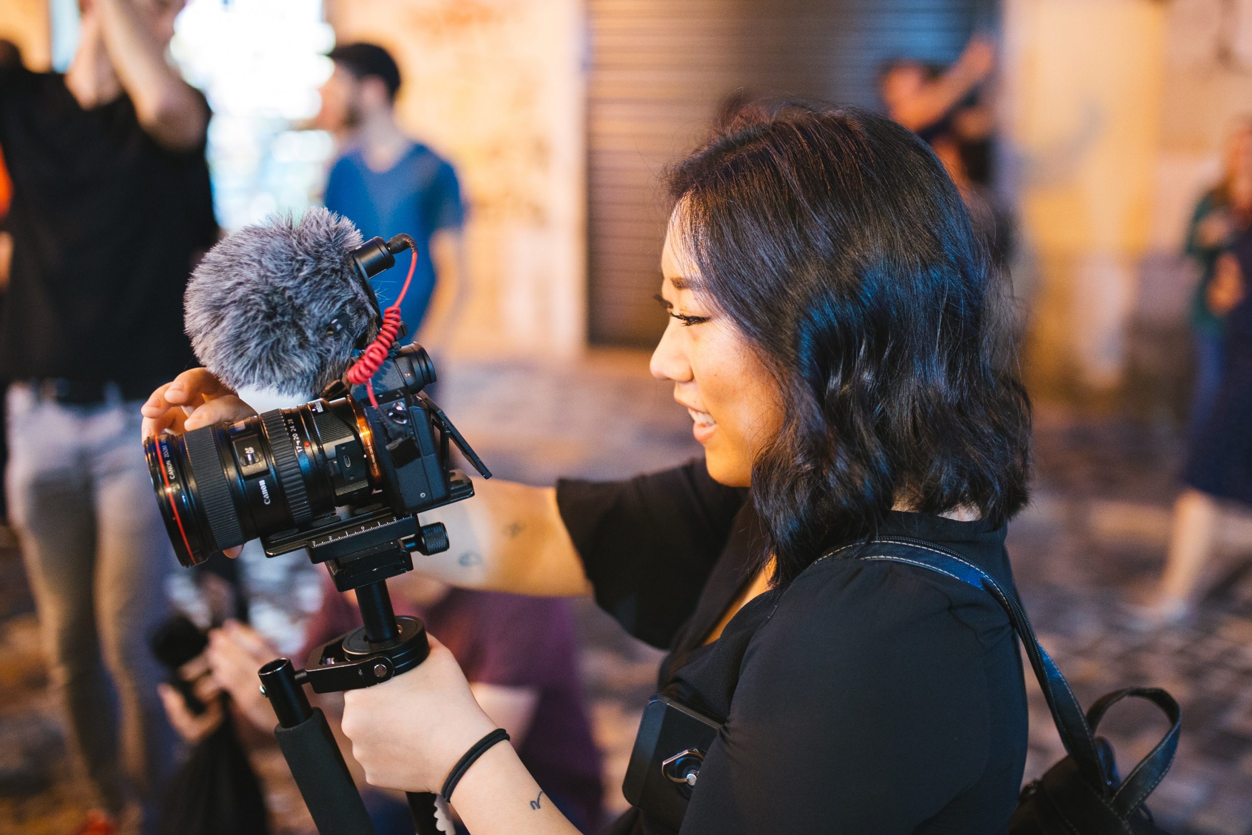 Young woman using DSLR camera